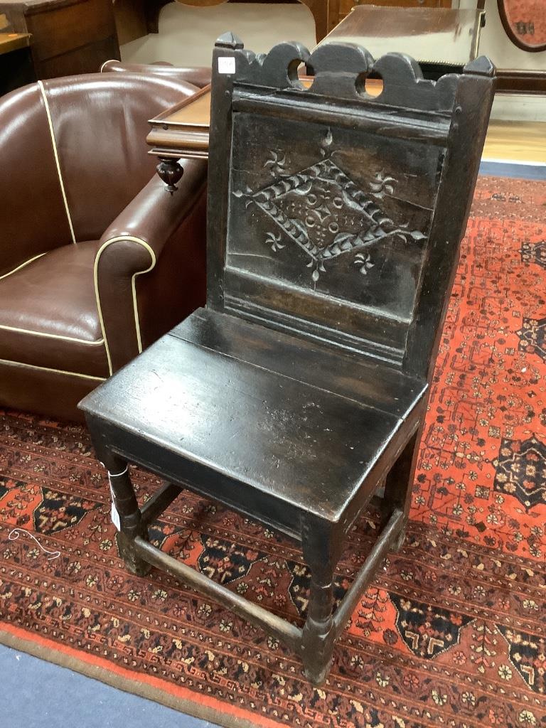 A 17th century and later oak panelled back stool with carved lozenge decoration, width 47cm, depth 38cm, height 91cm